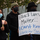 People listen during a vigil for Manuel Ellis, a Black man whose March death while in Tacoma Police custody was recently found to be a homicide, according to the Pierce County Medical Examiner’s Office, near the site of his death on June 3, 2020 in Tacoma, Washington.